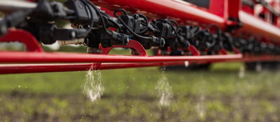 An Agrifac sprayer actively spraying liquid over a field, contributing to crop health.