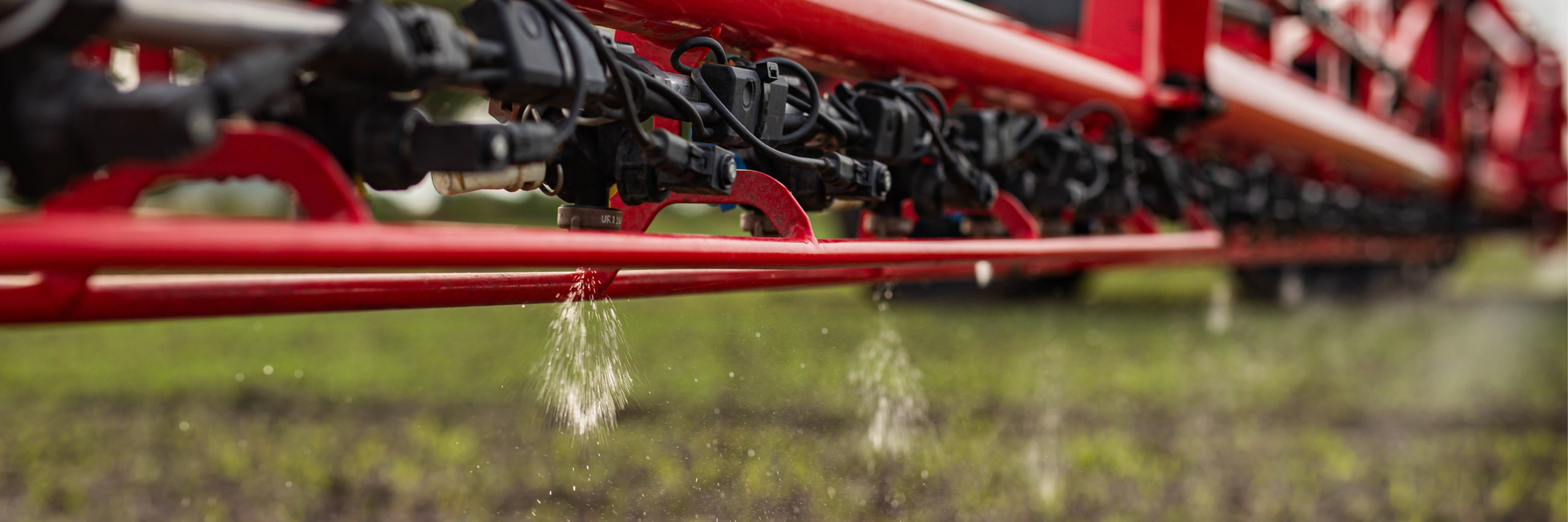 An Agrifac sprayer actively spraying liquid over a field, contributing to crop health.