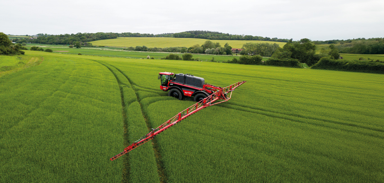 Aerial view of an Agrifac Vanguard sprayer driving in a vast agricultural field, showcasing modern farming techniques.