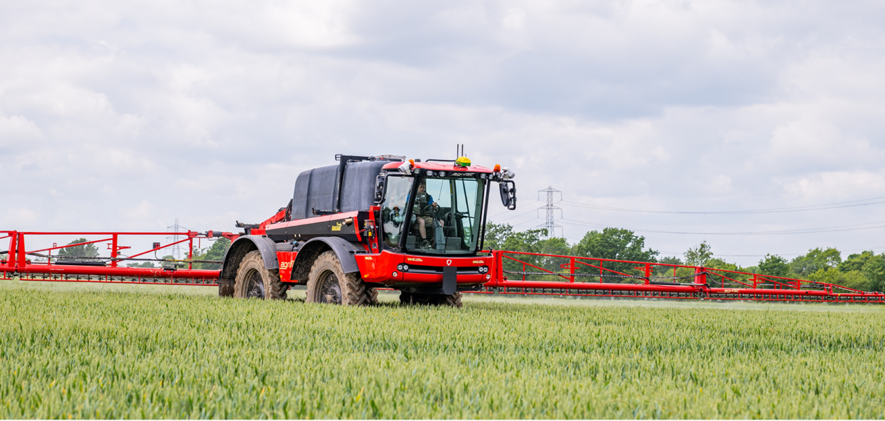 Aerial view of an Agrifac Vanguard sprayer driving in a vast agricultural field, showcasing modern farming techniques.