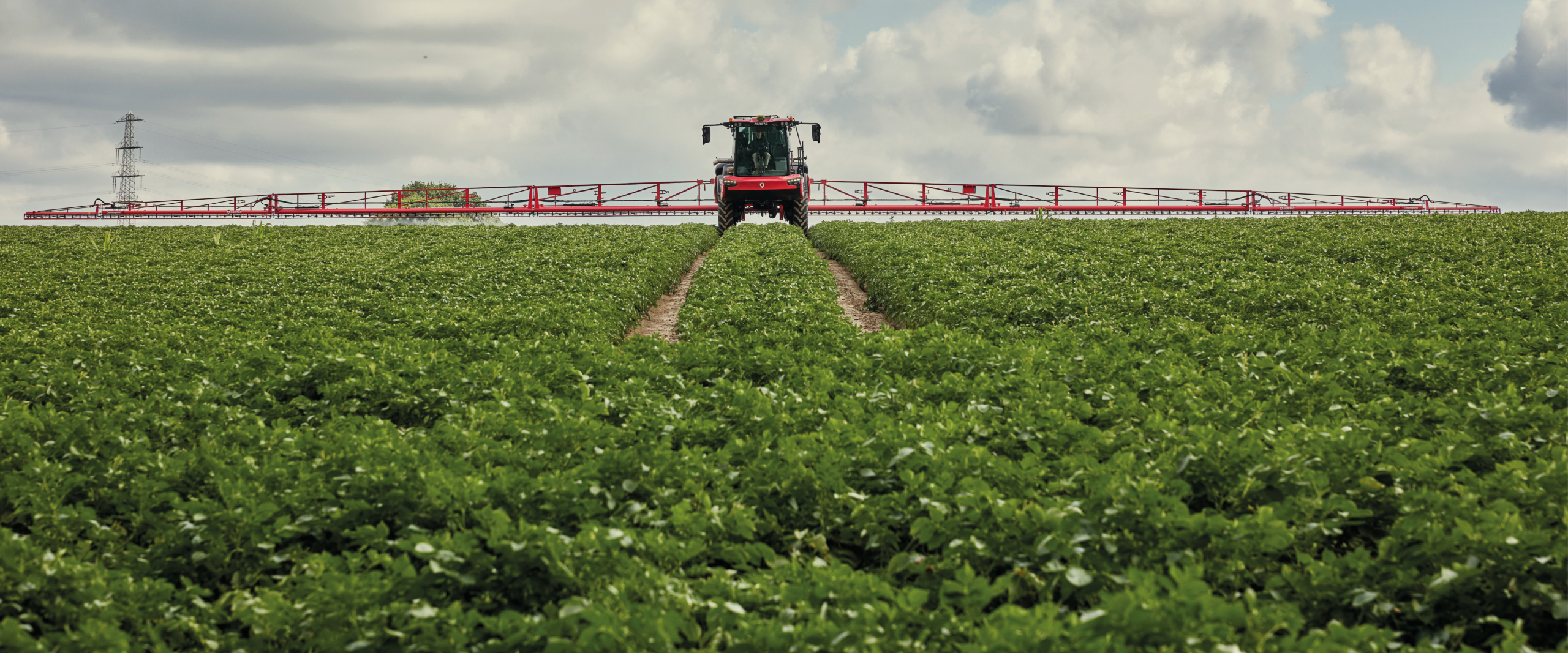 Agrifac sprayer spraying in a green field.