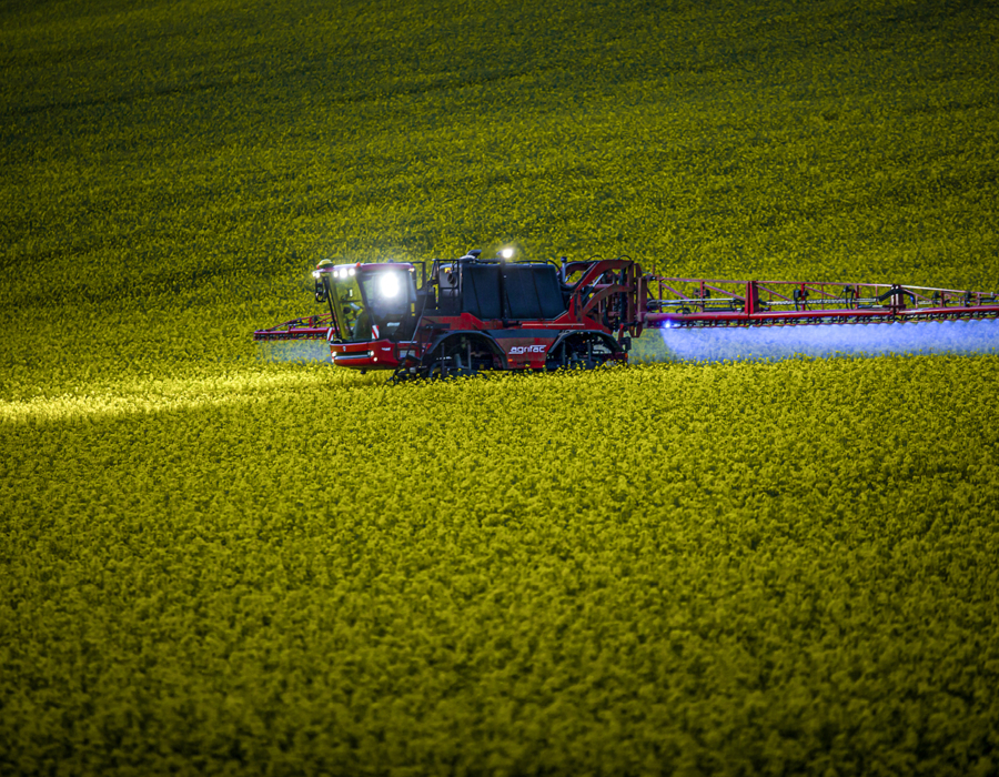 Condor Clearance operating in a field with lights on.