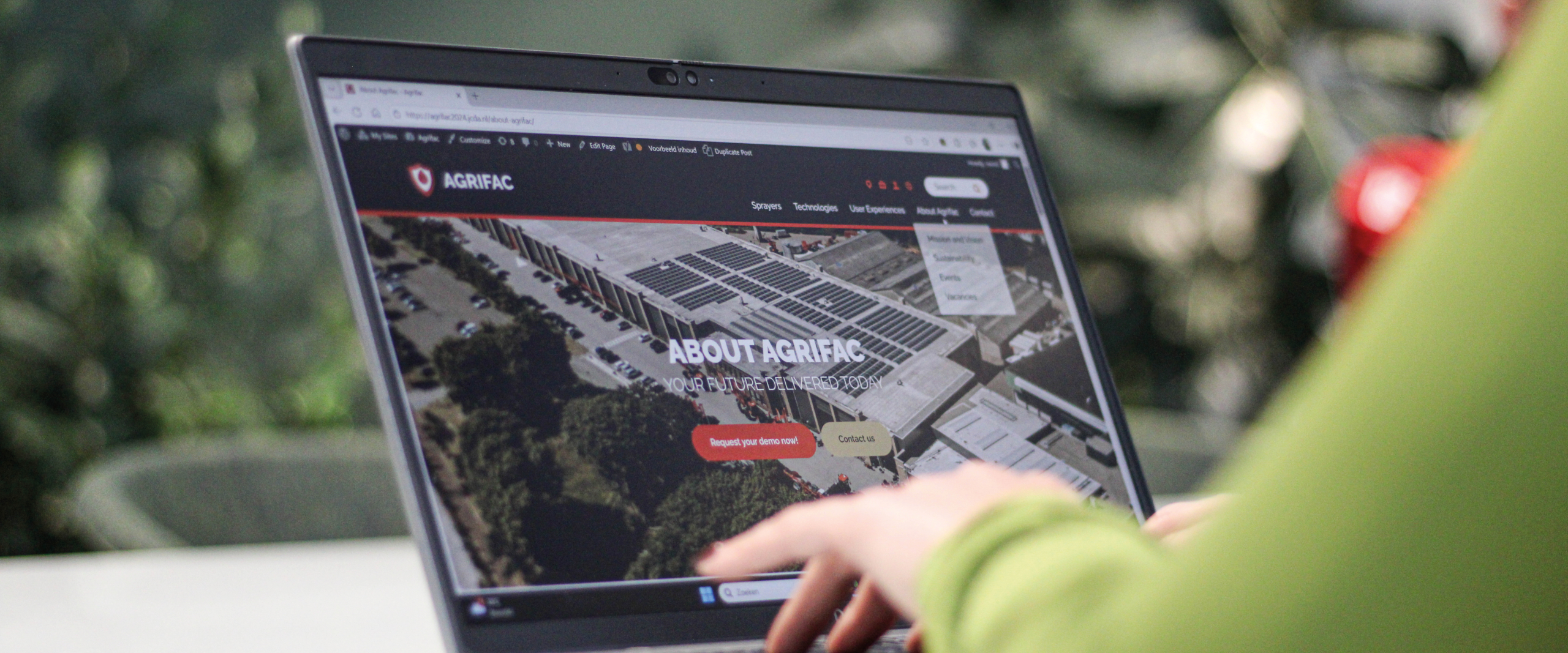 Person sitting behind a laptop.