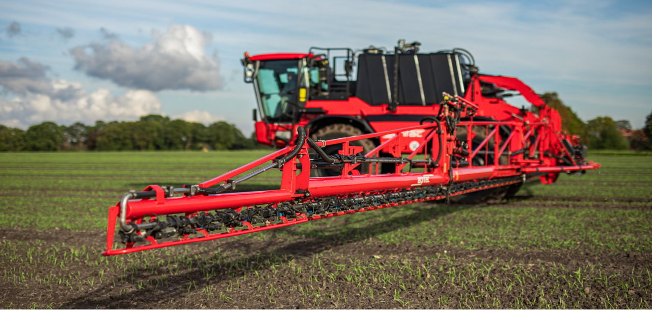 Aerial view of an Agrifac Condor sprayer driving through a large agricultural field.