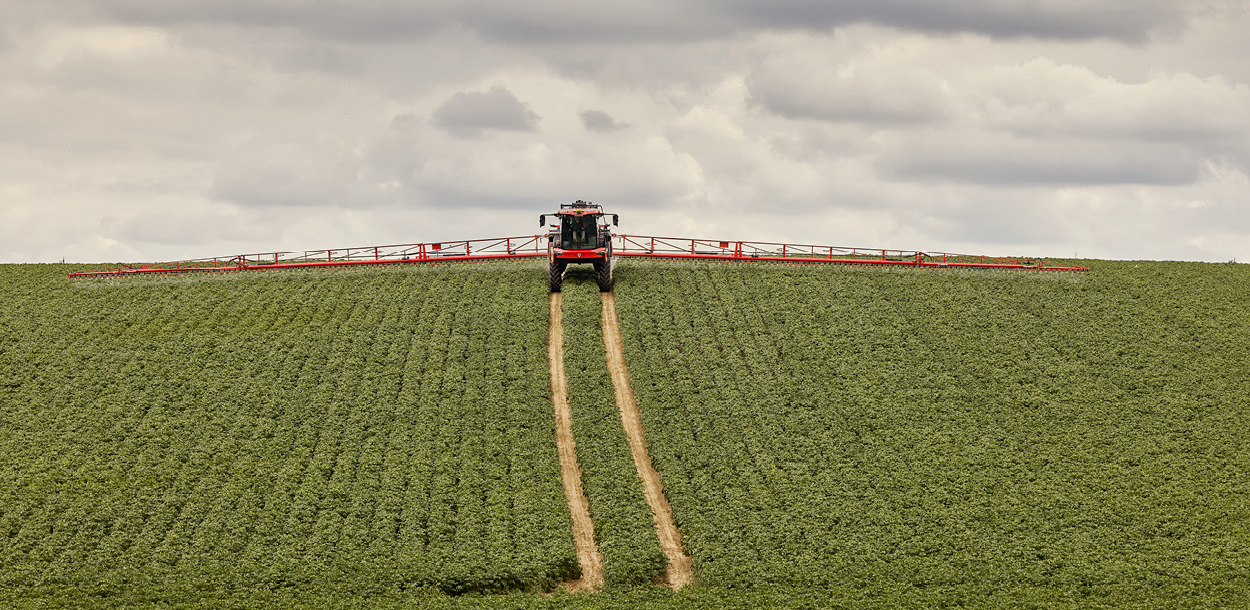 Agrifac sprayer spraying in a green field.