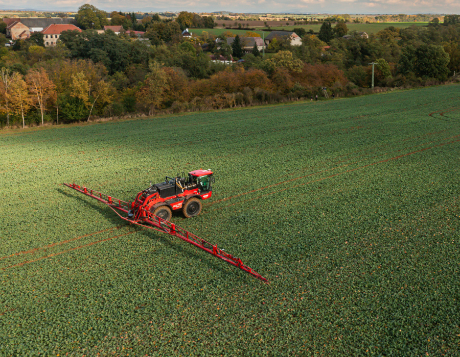Aerial view of an Agrifac sprayer driving in a vast agricultural field, showcasing modern farming techniques.